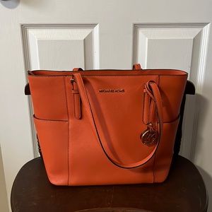 Michael Kors Orange handbag.